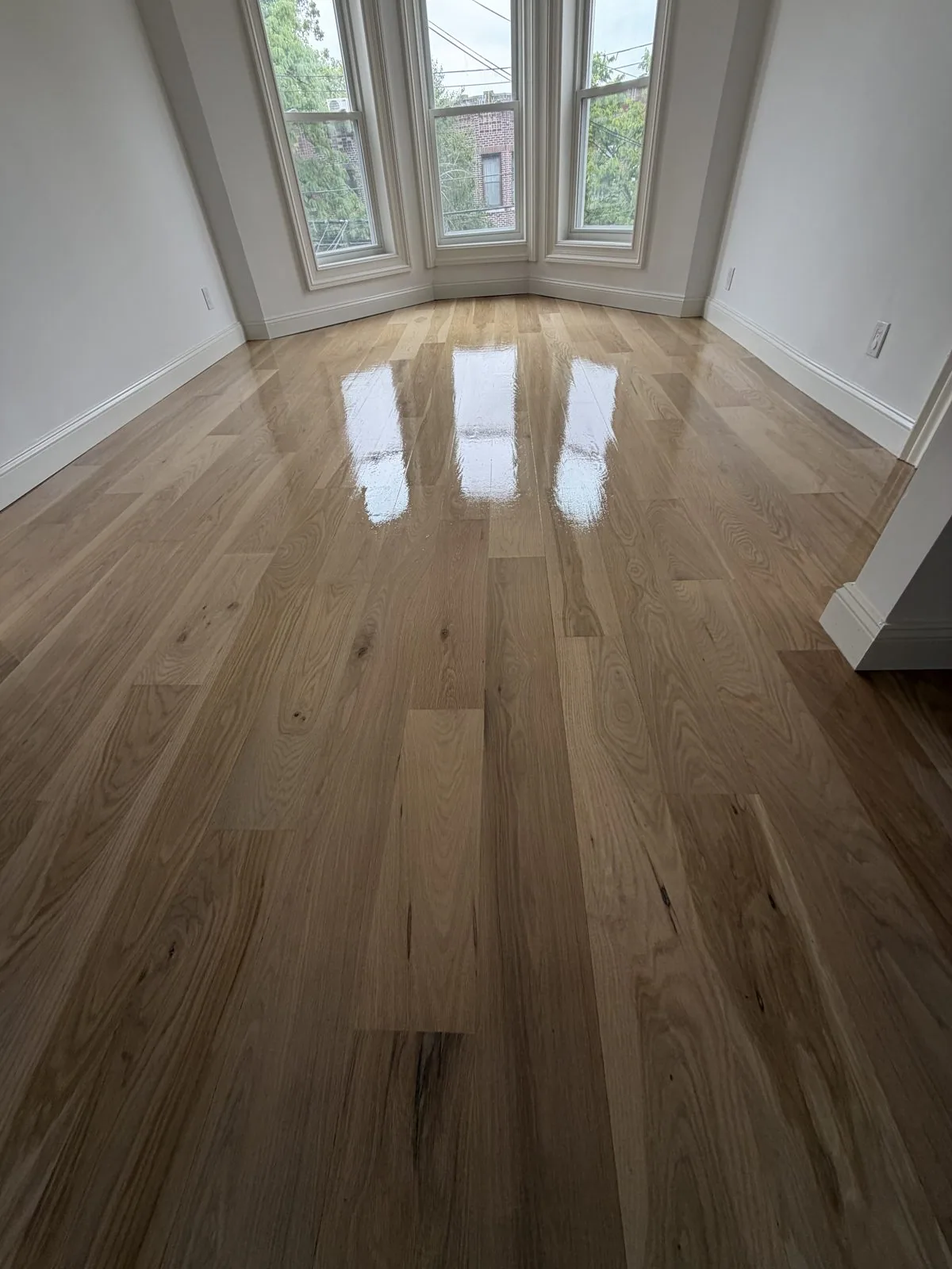 Natural oak floor in a room with a bay window