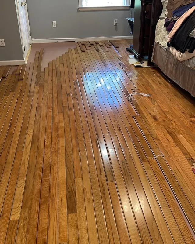 Damaged boards being repaired before refinishing