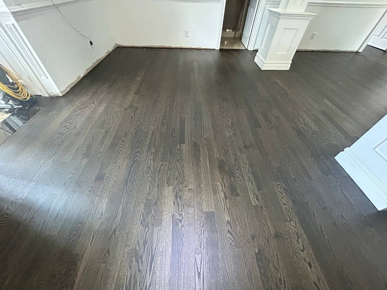 Dark gray stained floor in an empty living room
