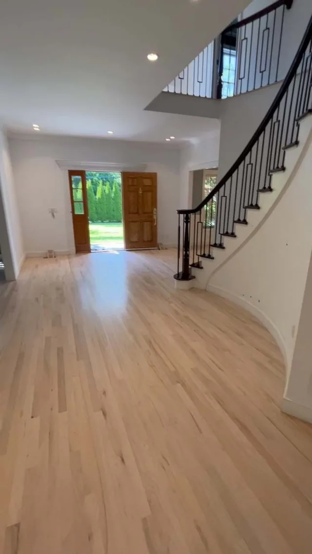 Light oak foyer with a curved staircase