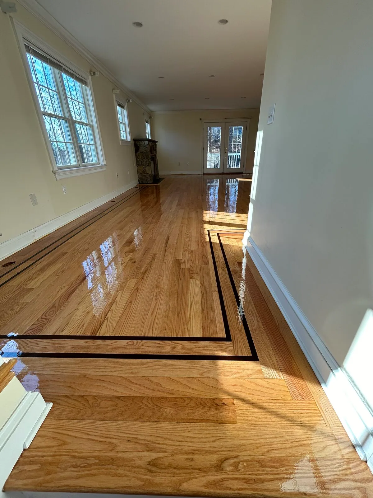 Natural oak hallway with a black inlaid border
