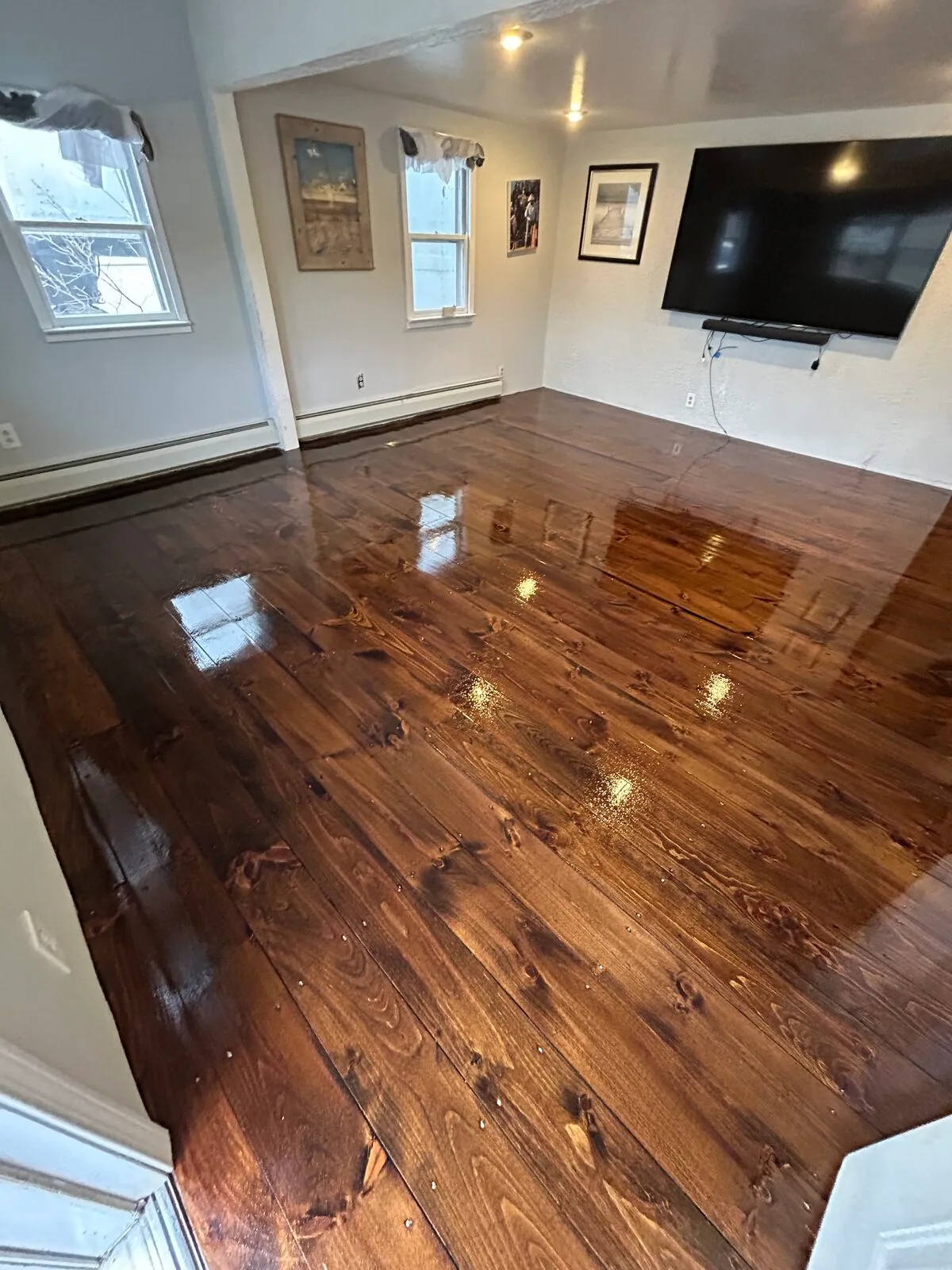 Dark walnut-toned hardwood with a gloss finish in a living room