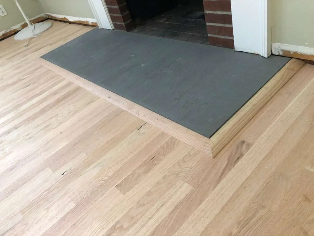 New hardwood installed around a raised hearth