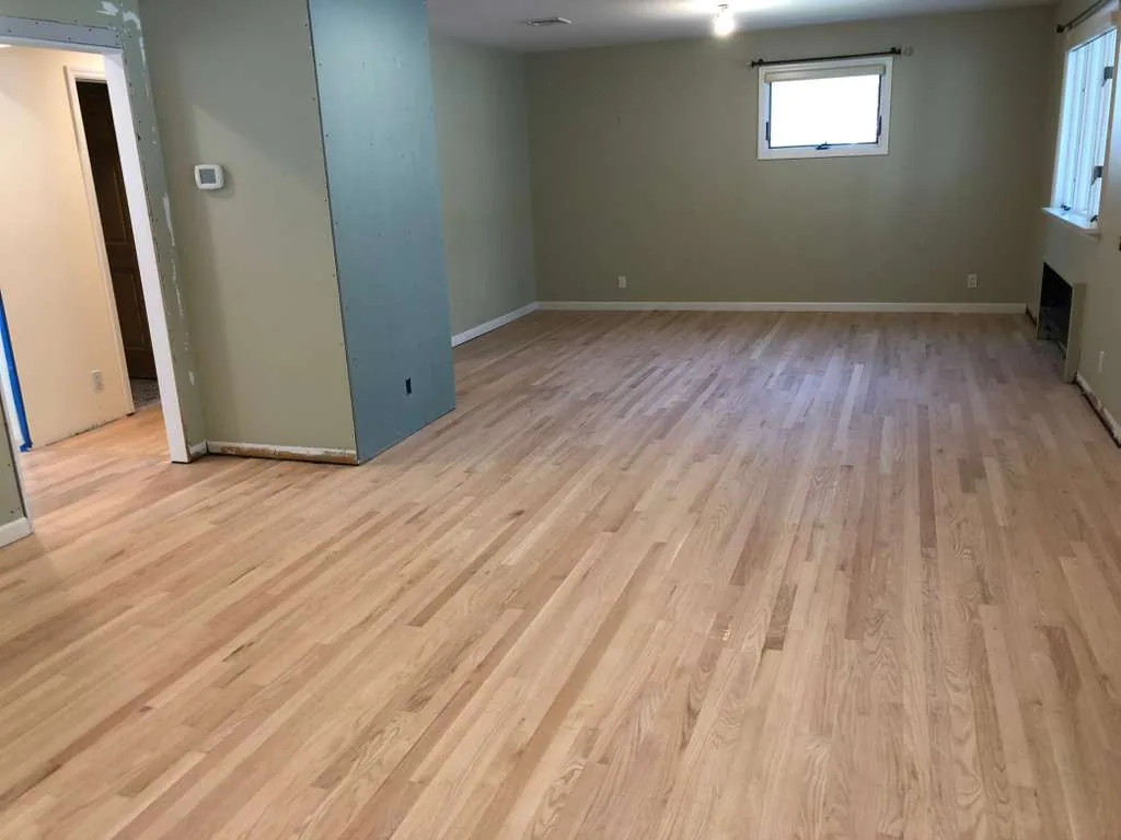 Unfinished oak flooring installed in a lower-level room