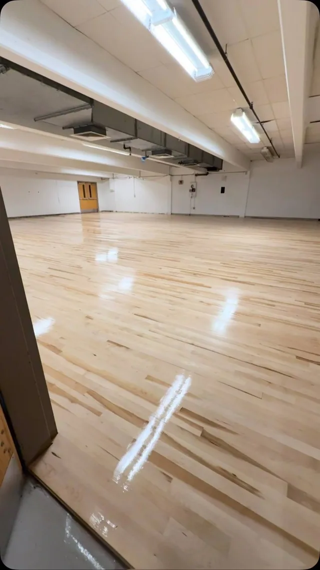 High-gloss maple floor in a large open hall