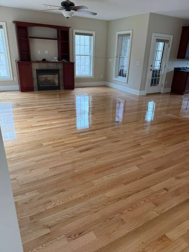Refinished natural red oak in a living room with a fireplace